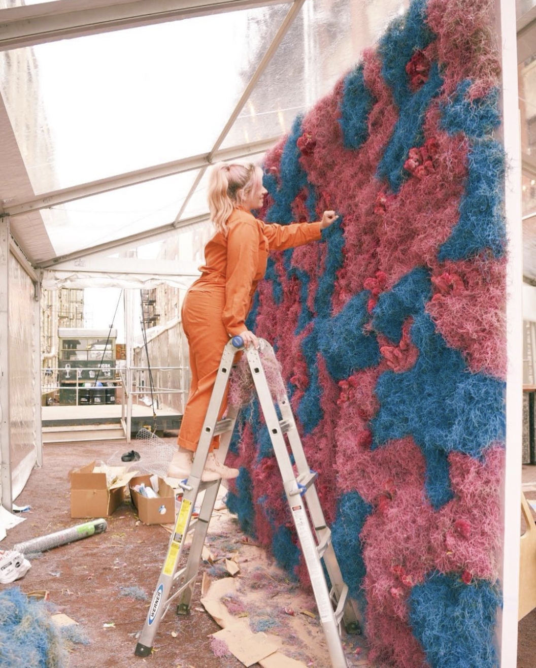 East Olivia working on a floral installation.