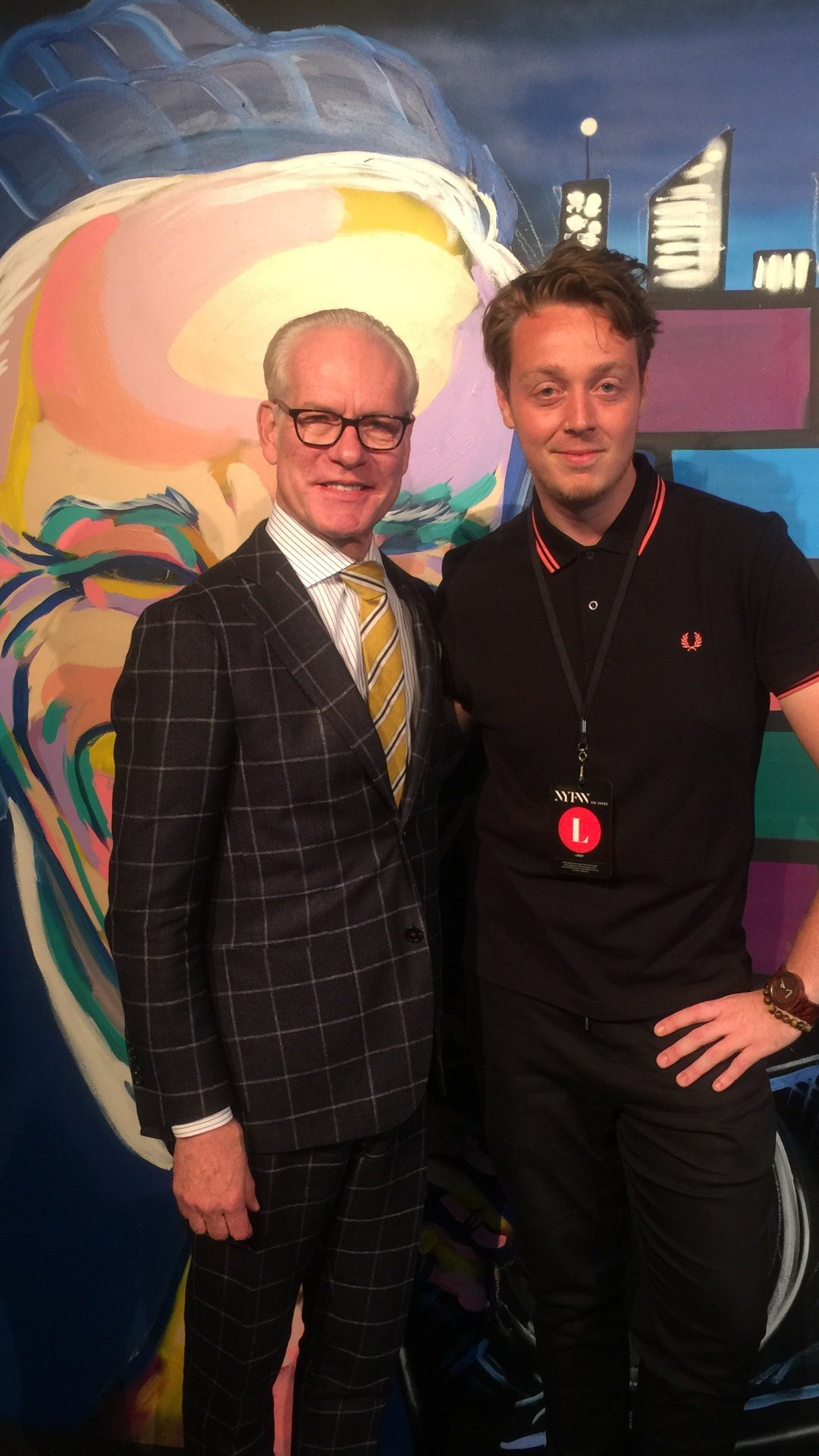 Coffee artist BaristArt poses with Tim Gunn post portrait.