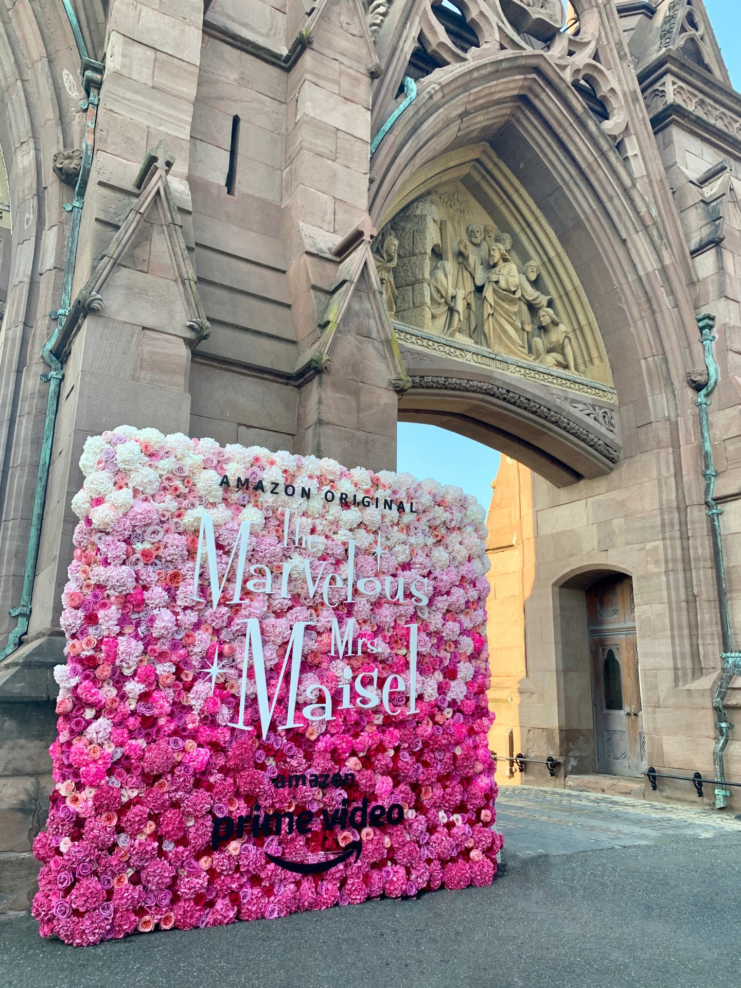 A perfectly pink ombrรฉ flower wall turned heads at an outdoor screening of Amazon Prime Video's hit series The Marvelous Mrs. Maisel at Green-Wood Cemetery.