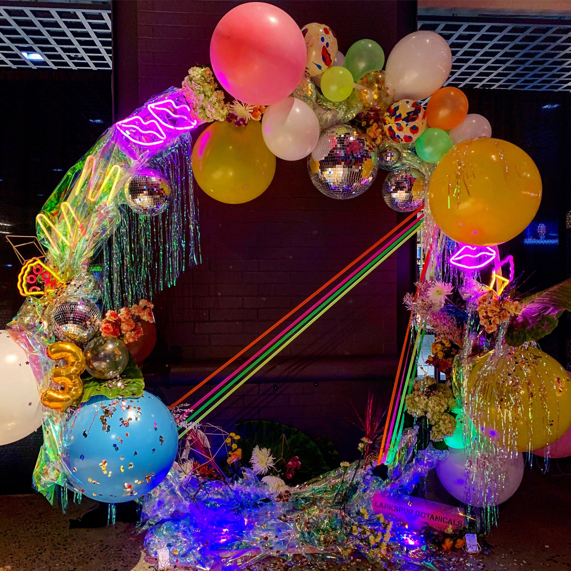 Reused tinsel and balloons by Larkspur Botanicals at the Midnight Market Neon Party.